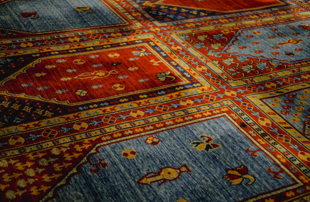 a close up of a colorful rug with many designs