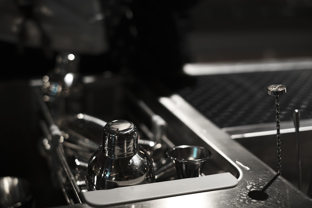 a stainless steel sink with a couple of spoons