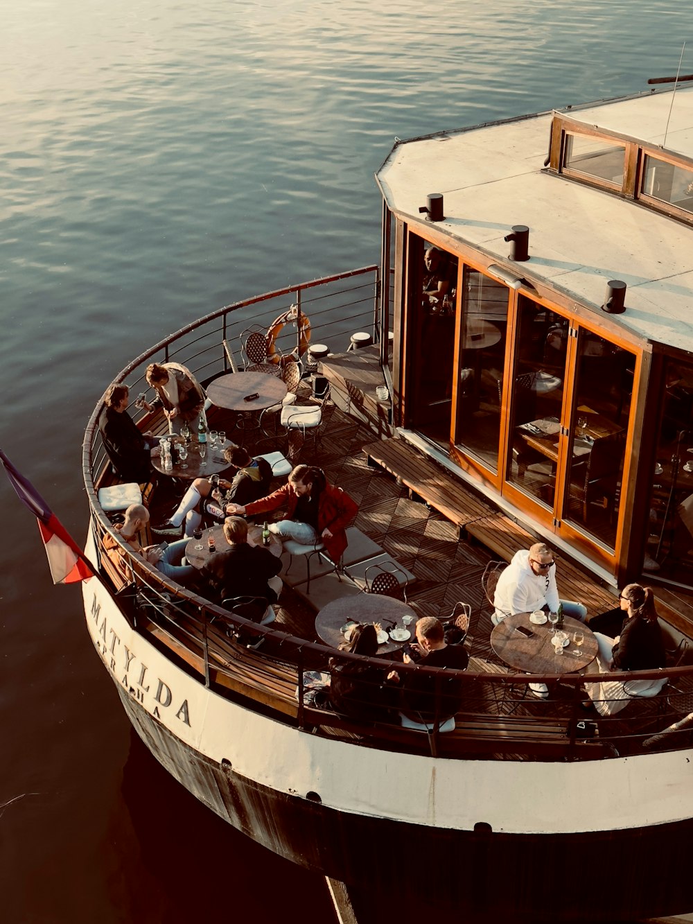 a group of people sitting on top of a boat