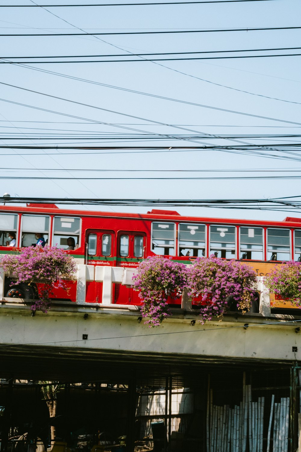 a red and white train traveling over a bridge