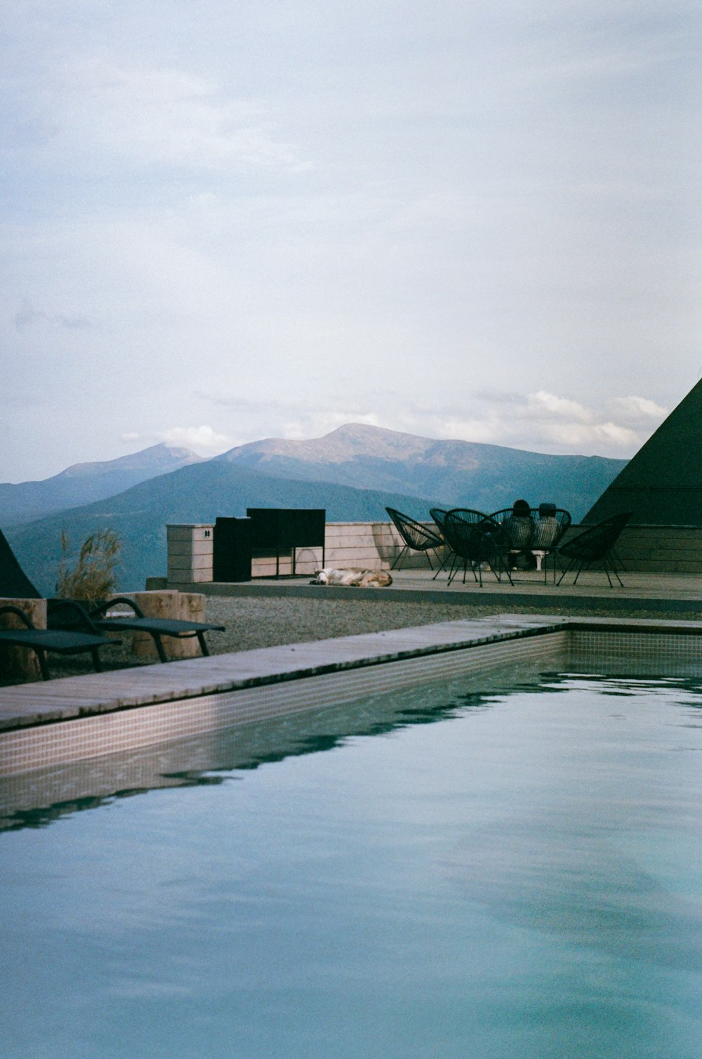 a swimming pool with a mountain view in the background