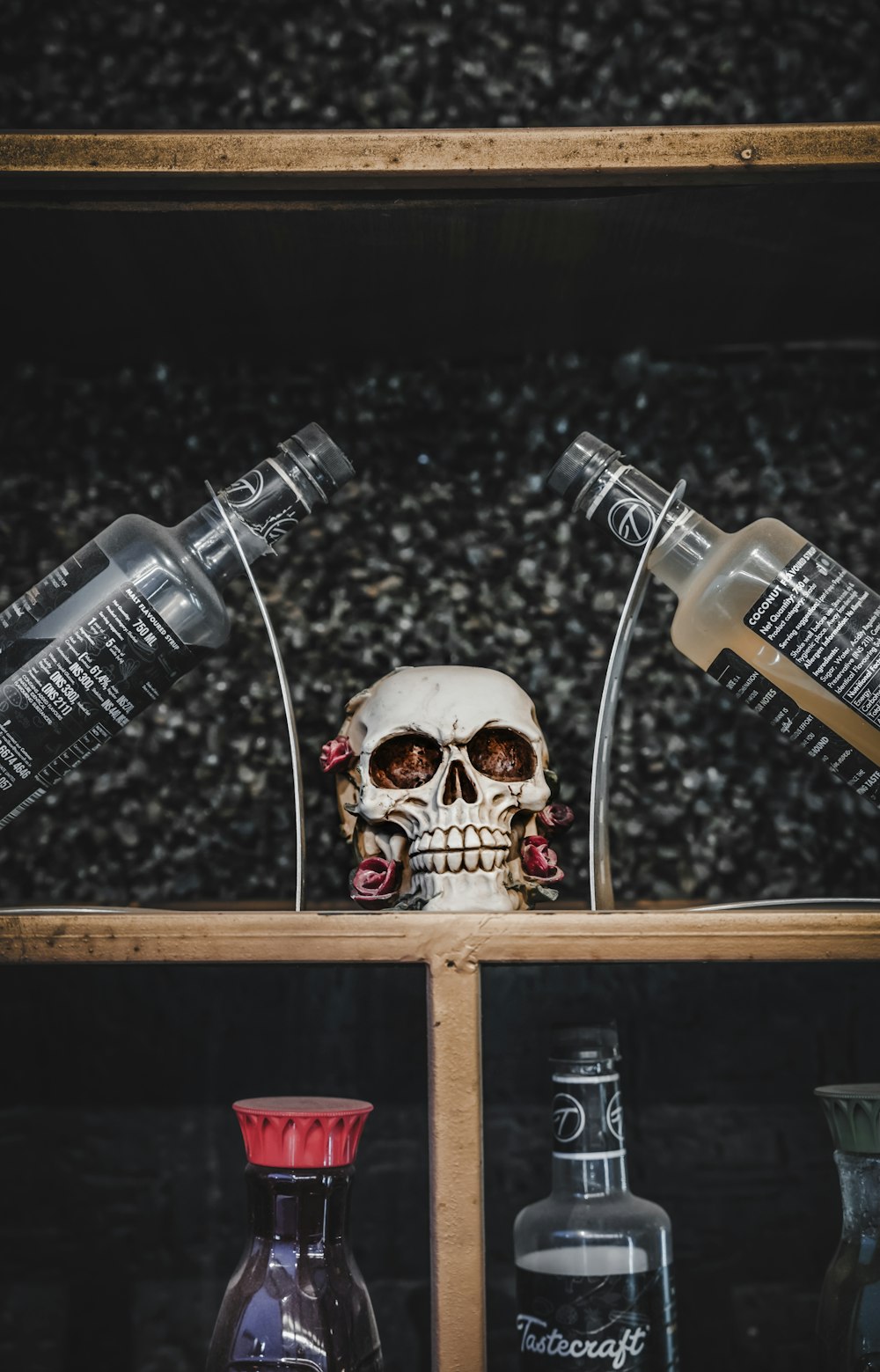 a skull sitting on top of a wooden shelf