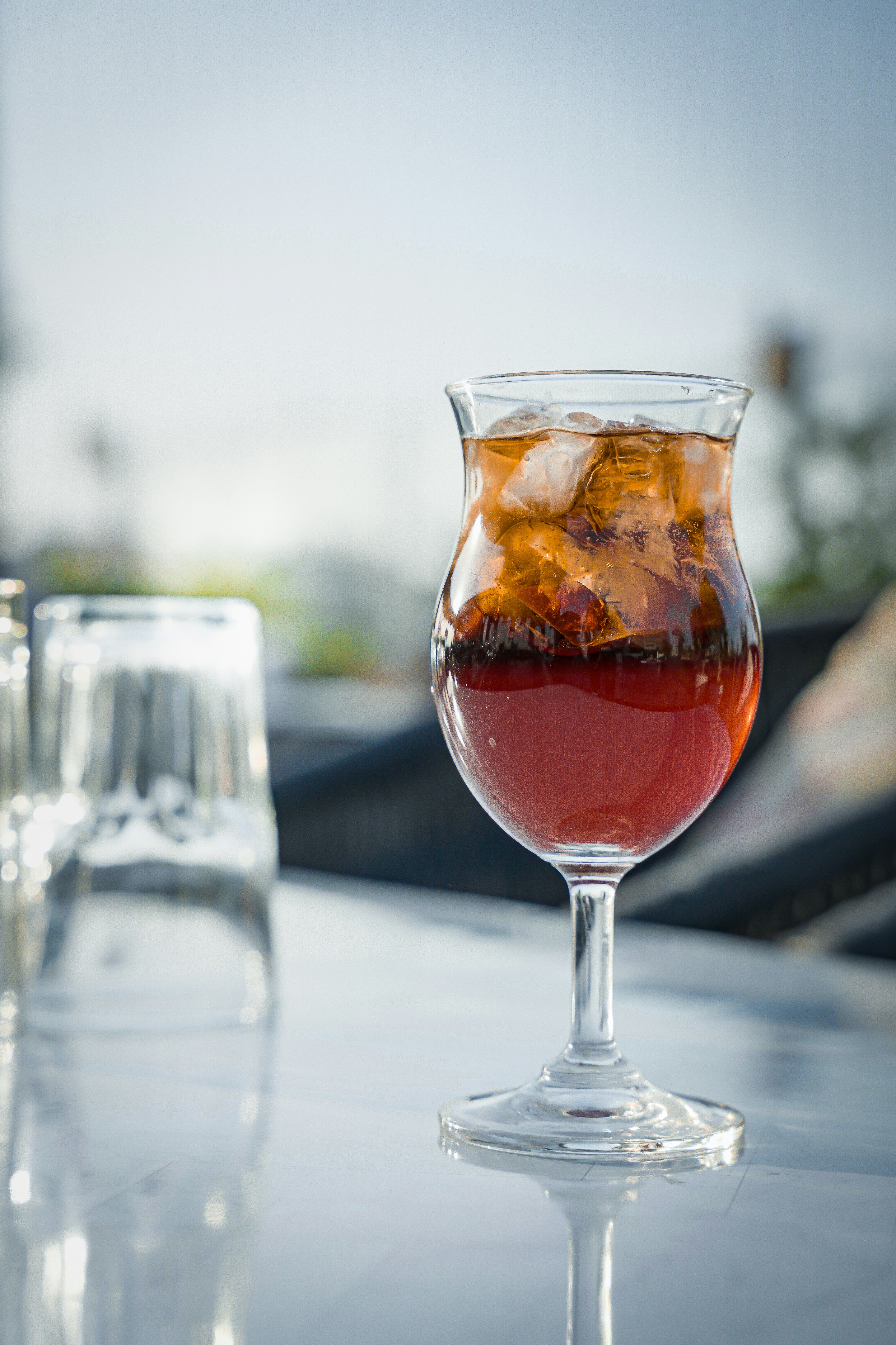 a glass filled with liquid sitting on top of a table