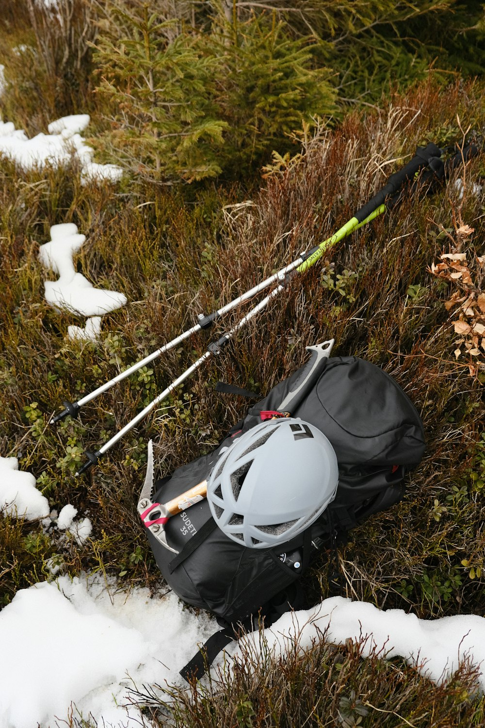 a helmet and skis laying in the snow