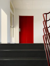 a set of stairs leading to a red door