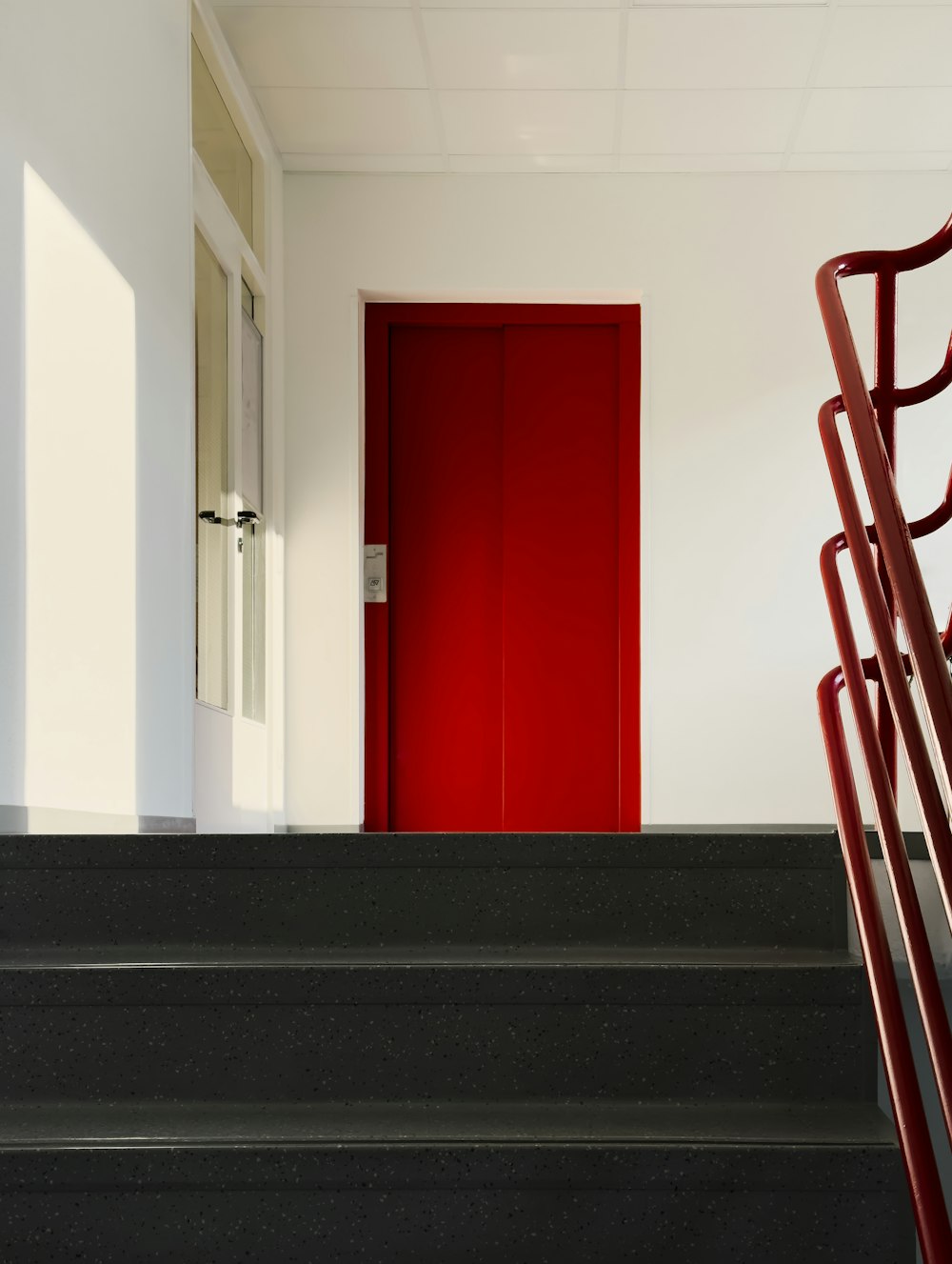 a set of stairs leading to a red door