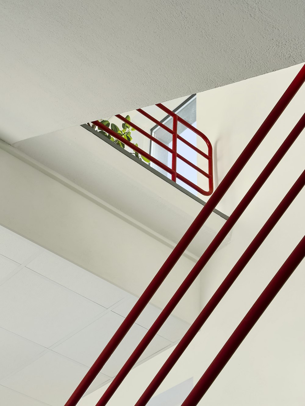 a red ladder hanging from the side of a building