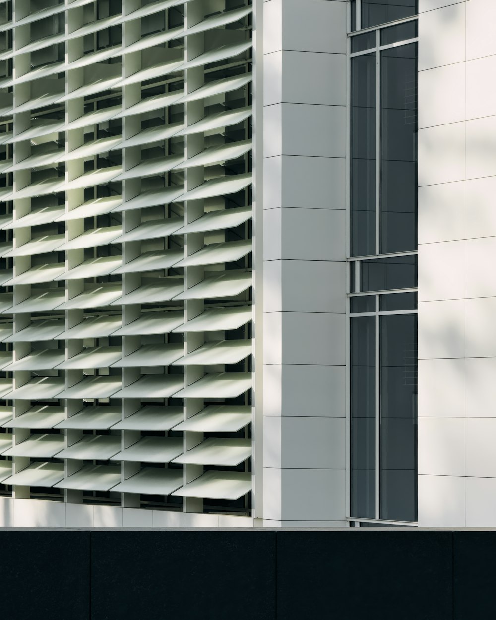 a tall white building with lots of windows