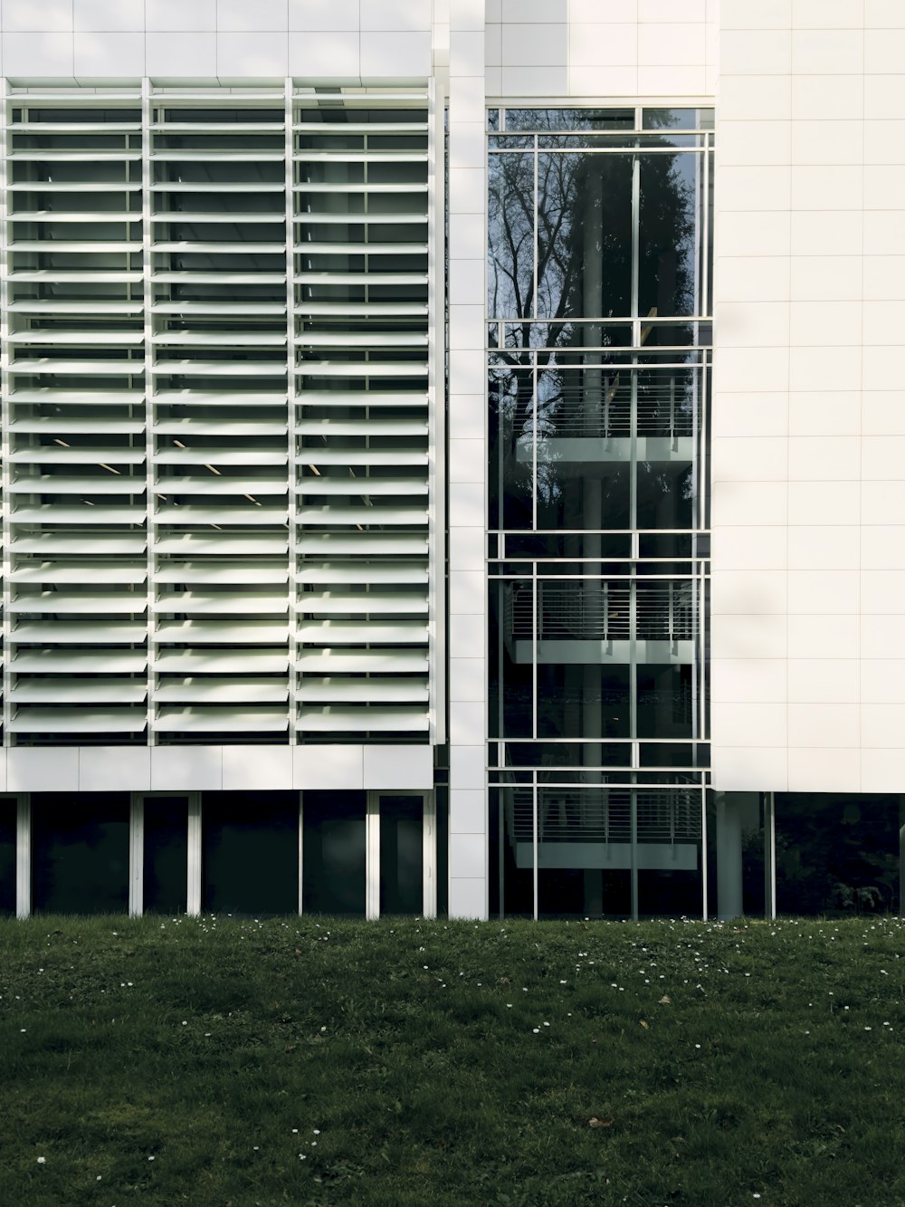 a building with a grassy field in front of it