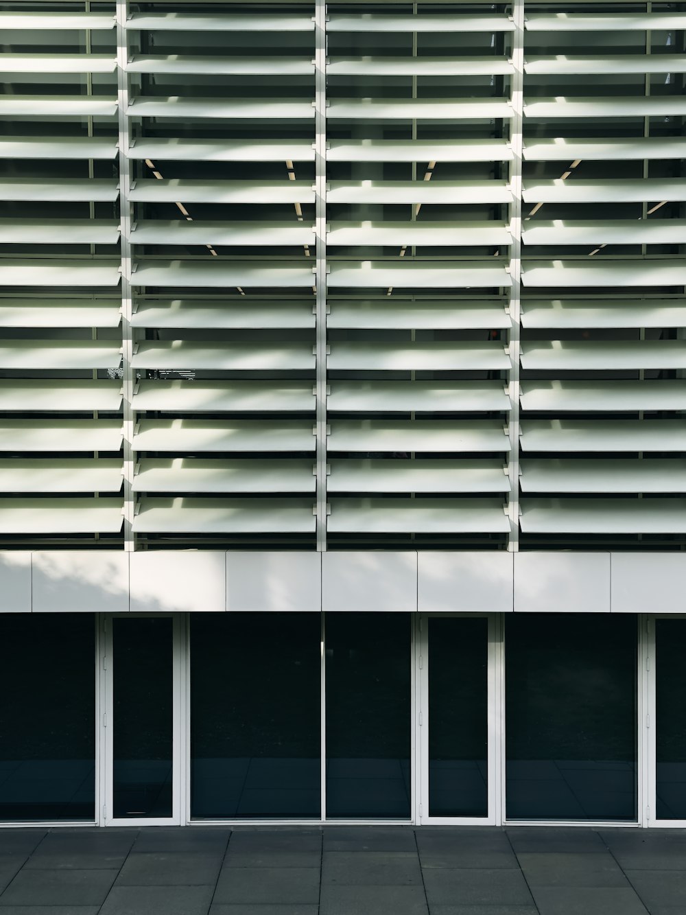 a person sitting on a bench in front of a building