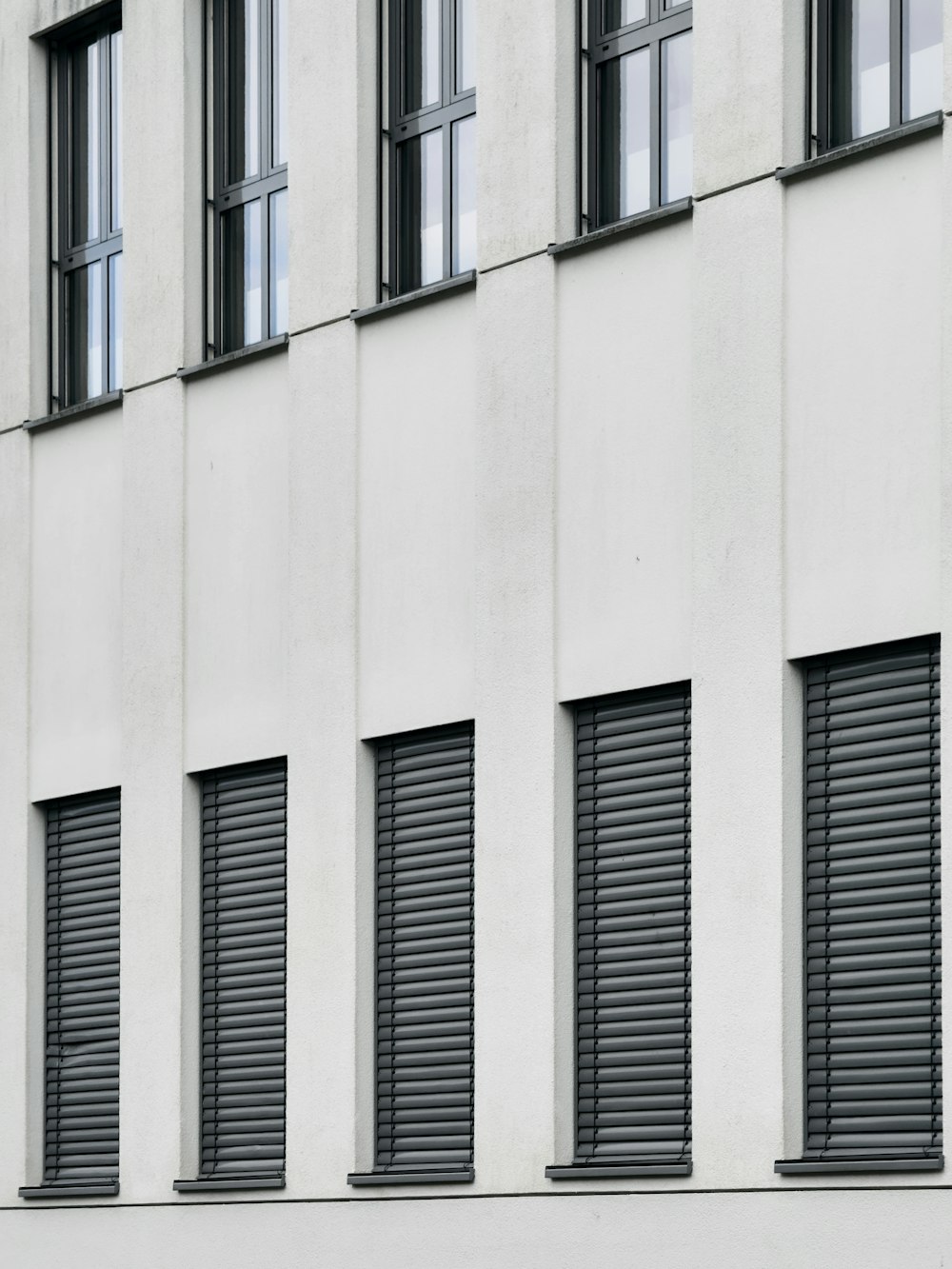 a black and white photo of a building with many windows