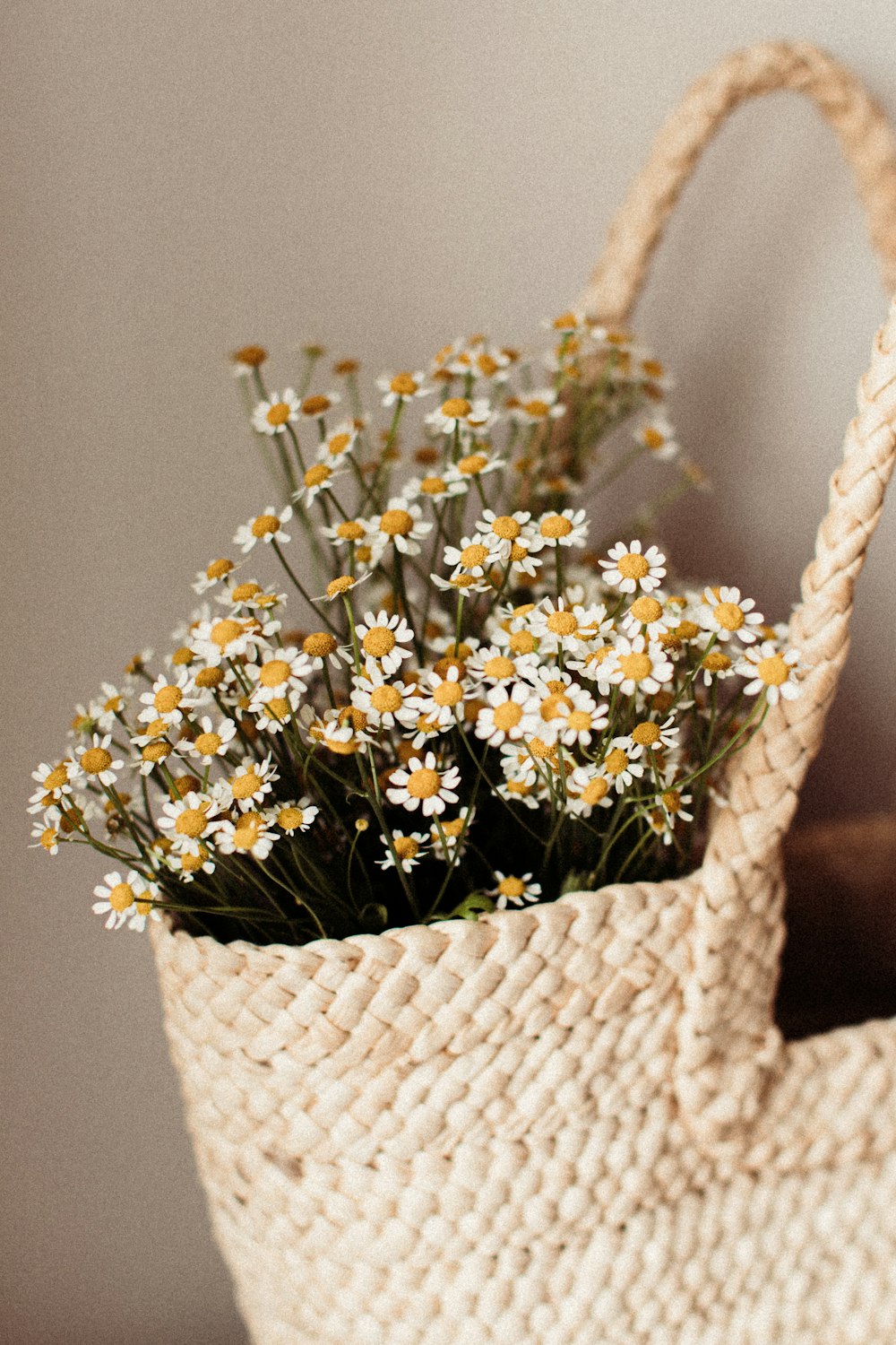 a basket filled with flowers sitting on top of a table