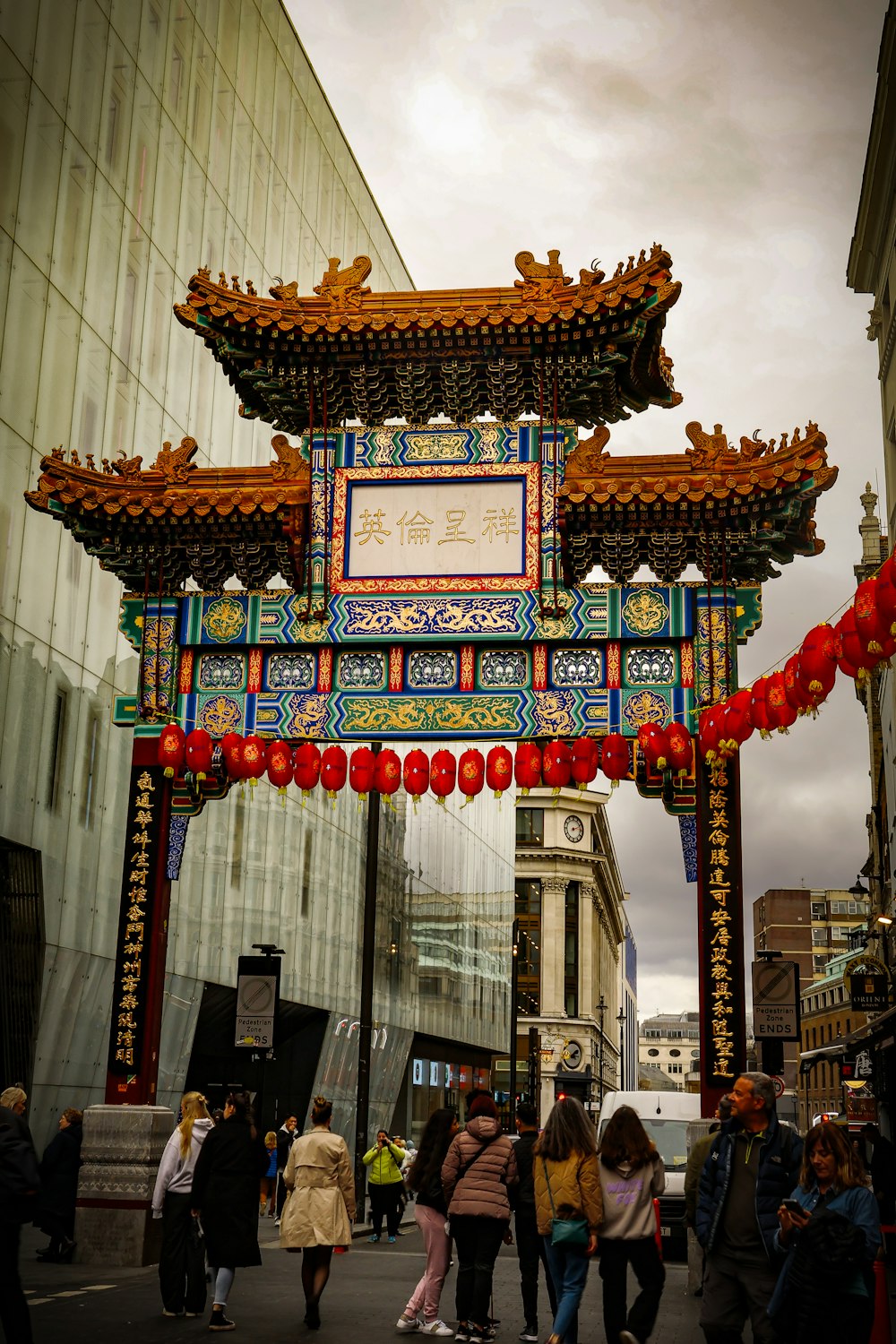 a group of people walking under a chinese arch