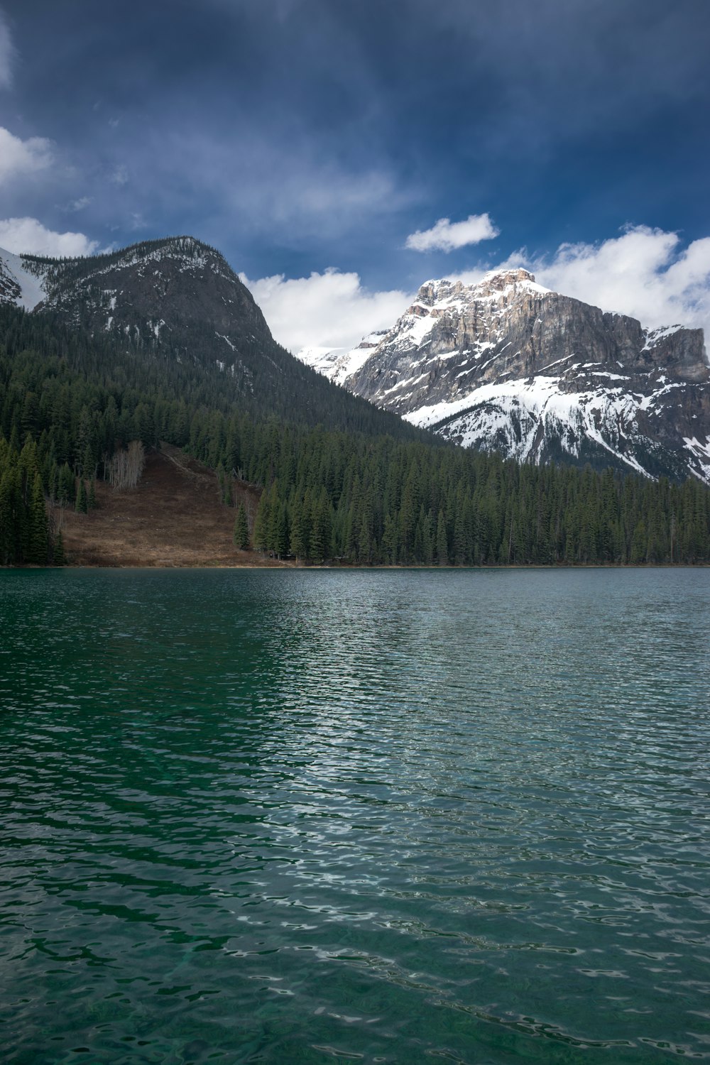 a large body of water with a mountain in the background