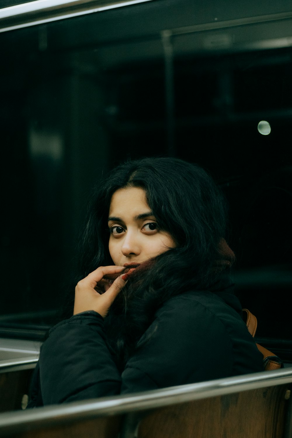 a woman sitting on a train looking out the window