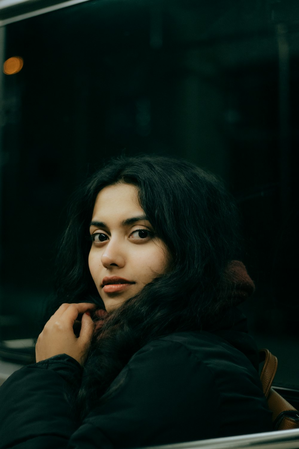 a woman sitting on a train looking out the window