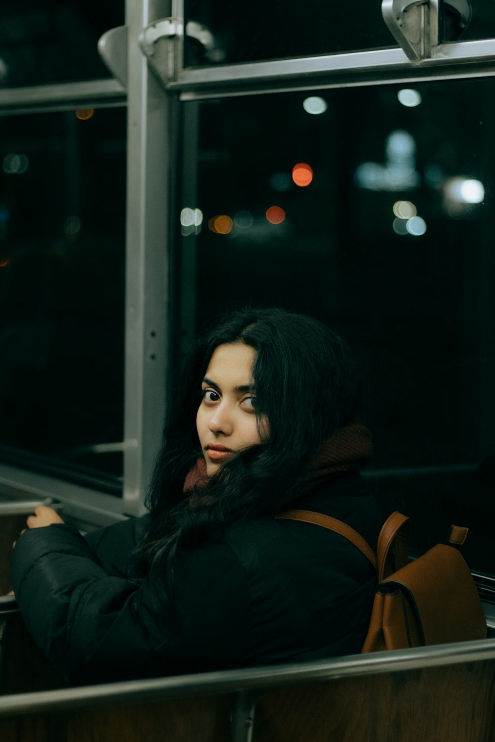 a woman sitting on a bus looking out the window