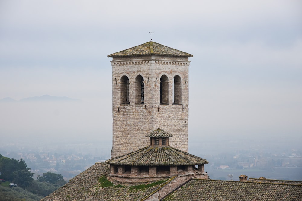 a tall tower with a cross on top of it