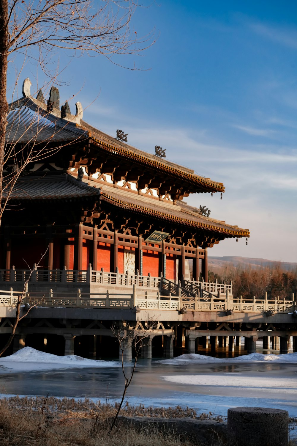 a bridge over a body of water with a building in the background