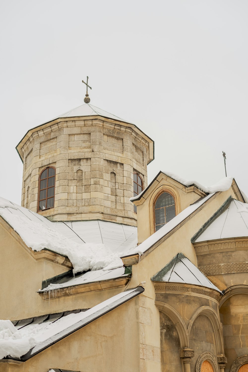 a church with a steeple covered in snow