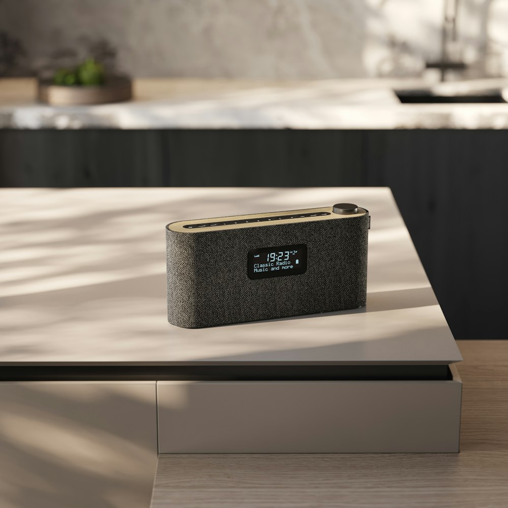 a black speaker sitting on top of a table