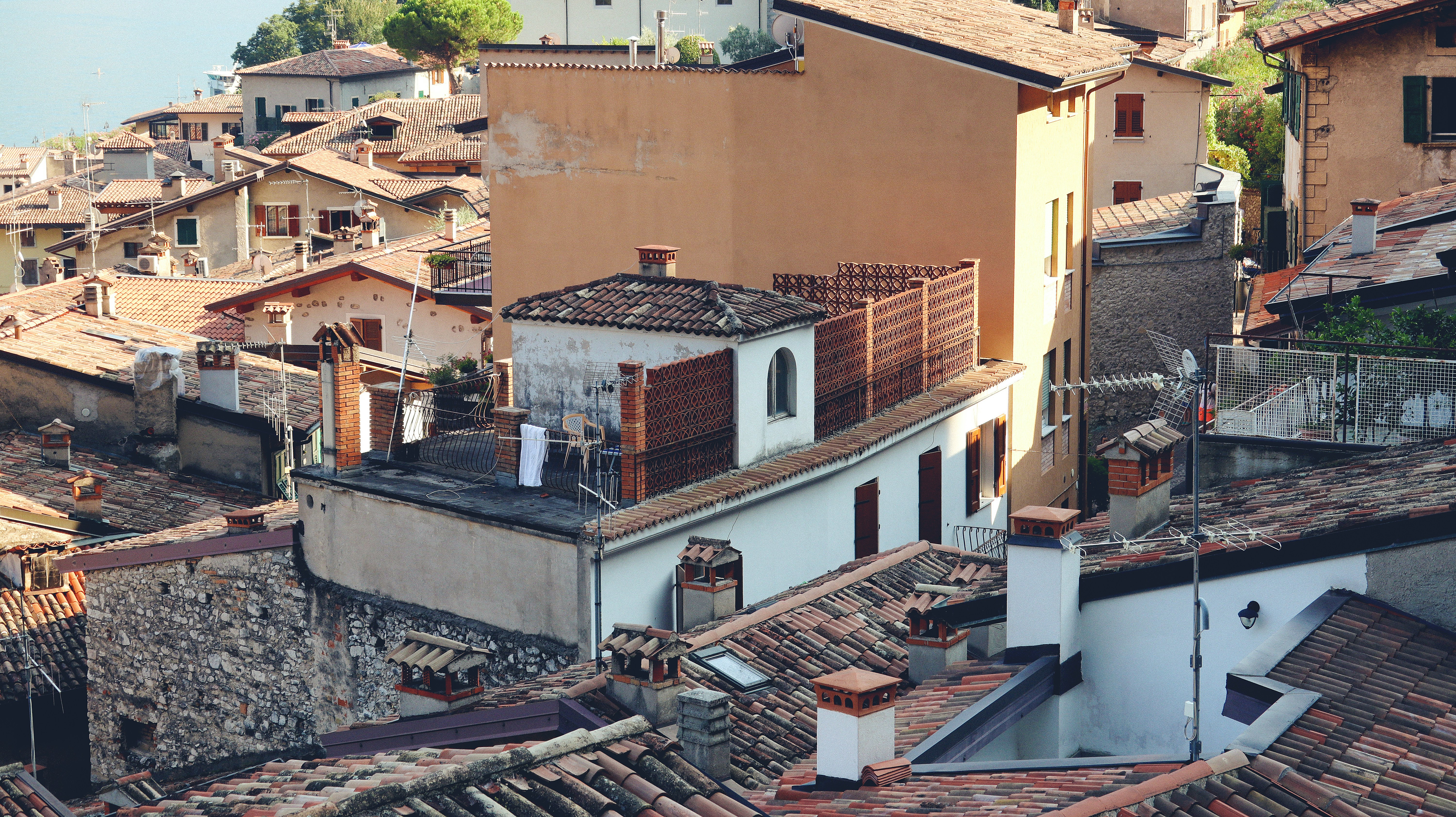 a view of a city with rooftops and buildings, Italian summer_23
