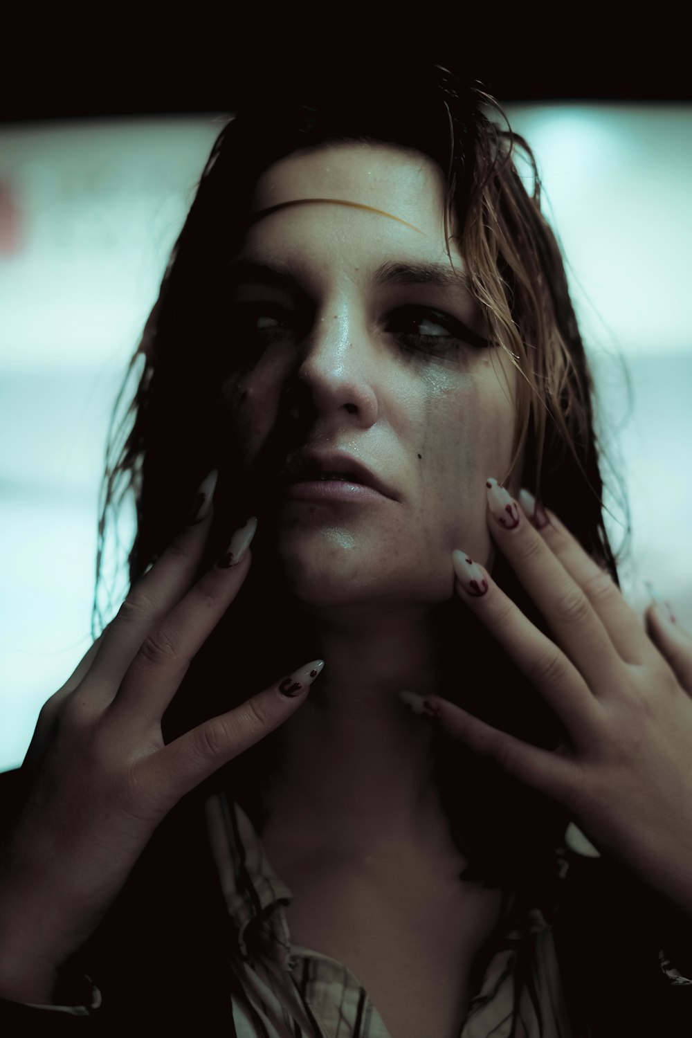 a woman holding her hands to her face