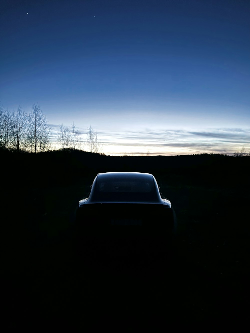 a car parked in a field at night