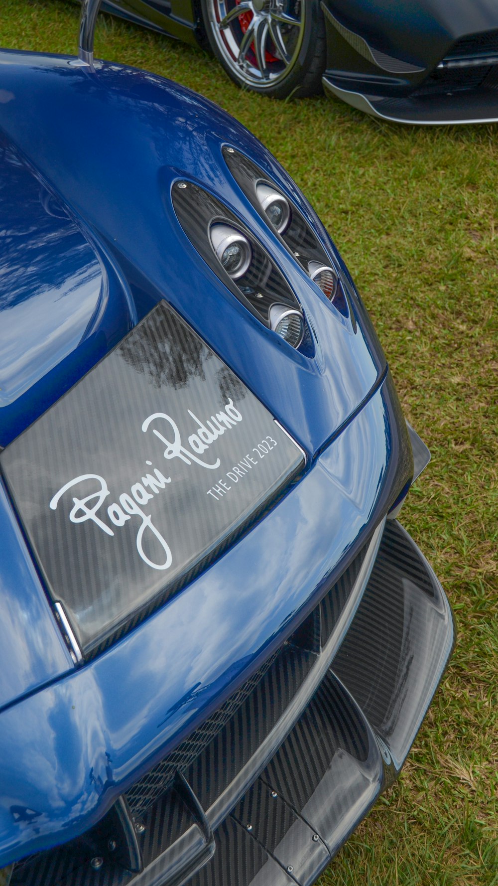 um close up da frente de um carro esportivo azul