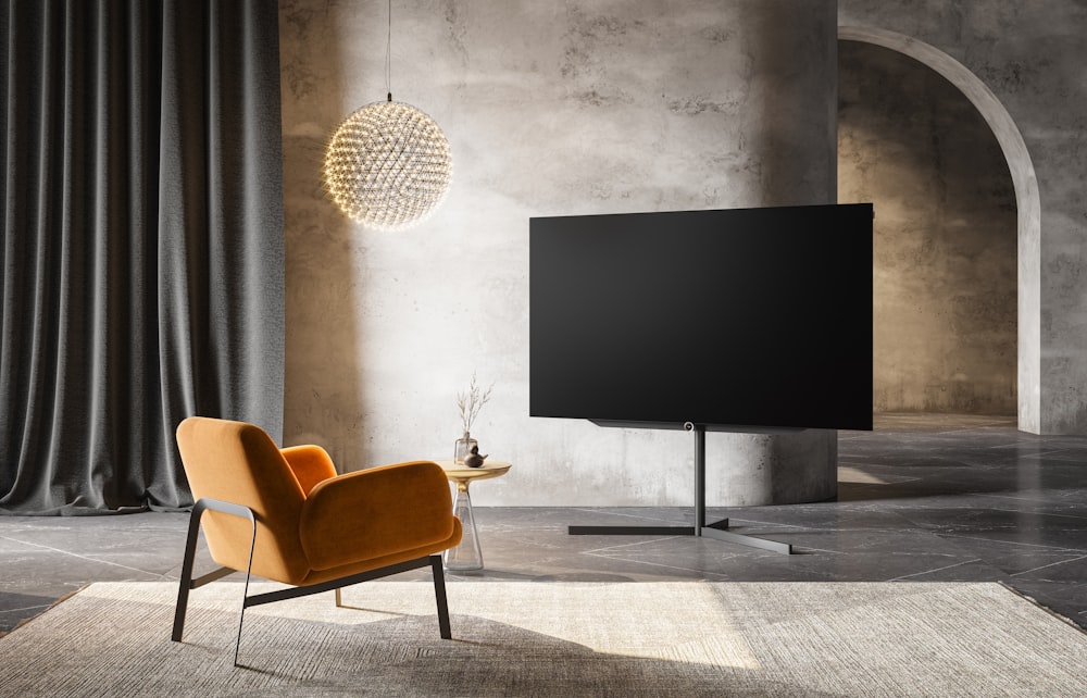 a living room with a chair and a flat screen tv