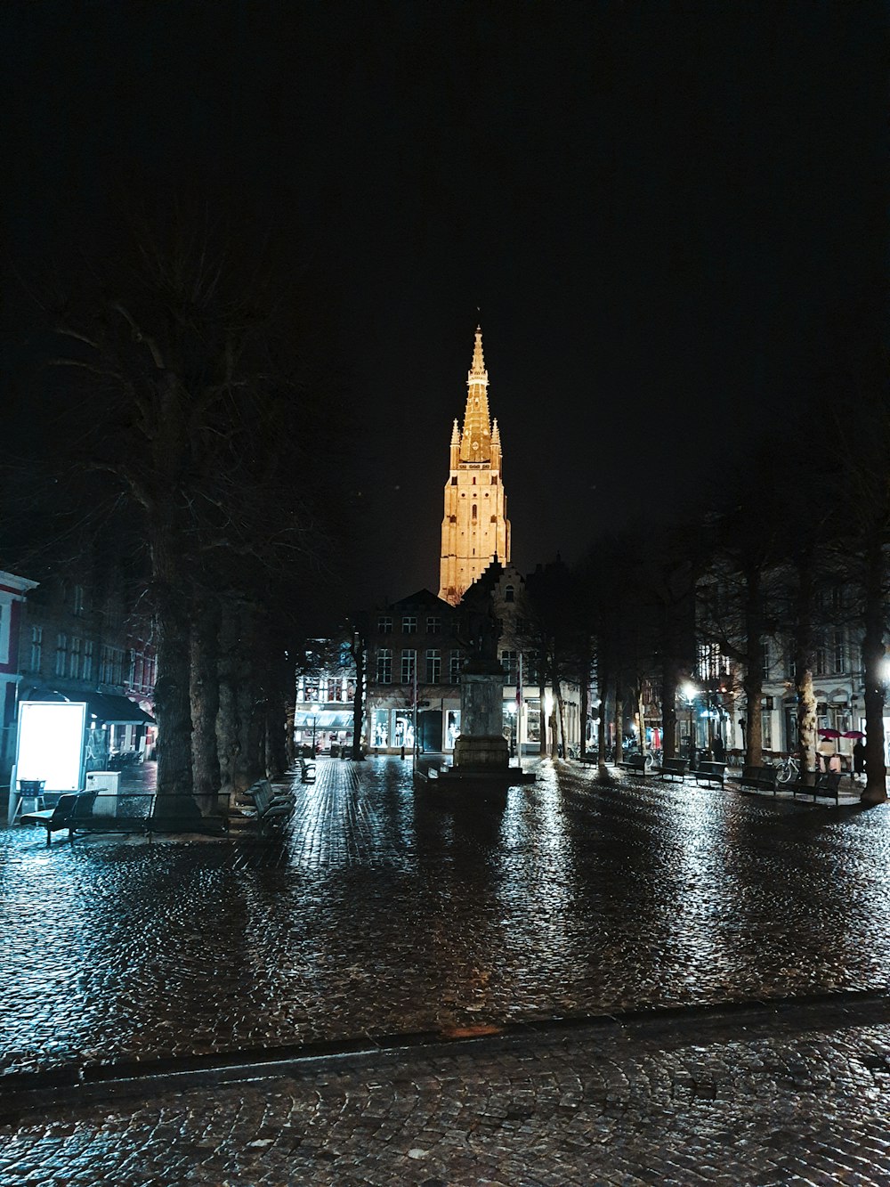 a large clock tower towering over a city at night