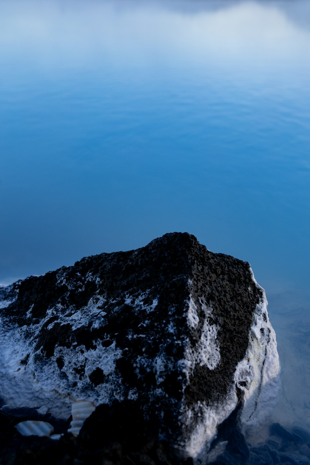 a rock in the middle of a body of water