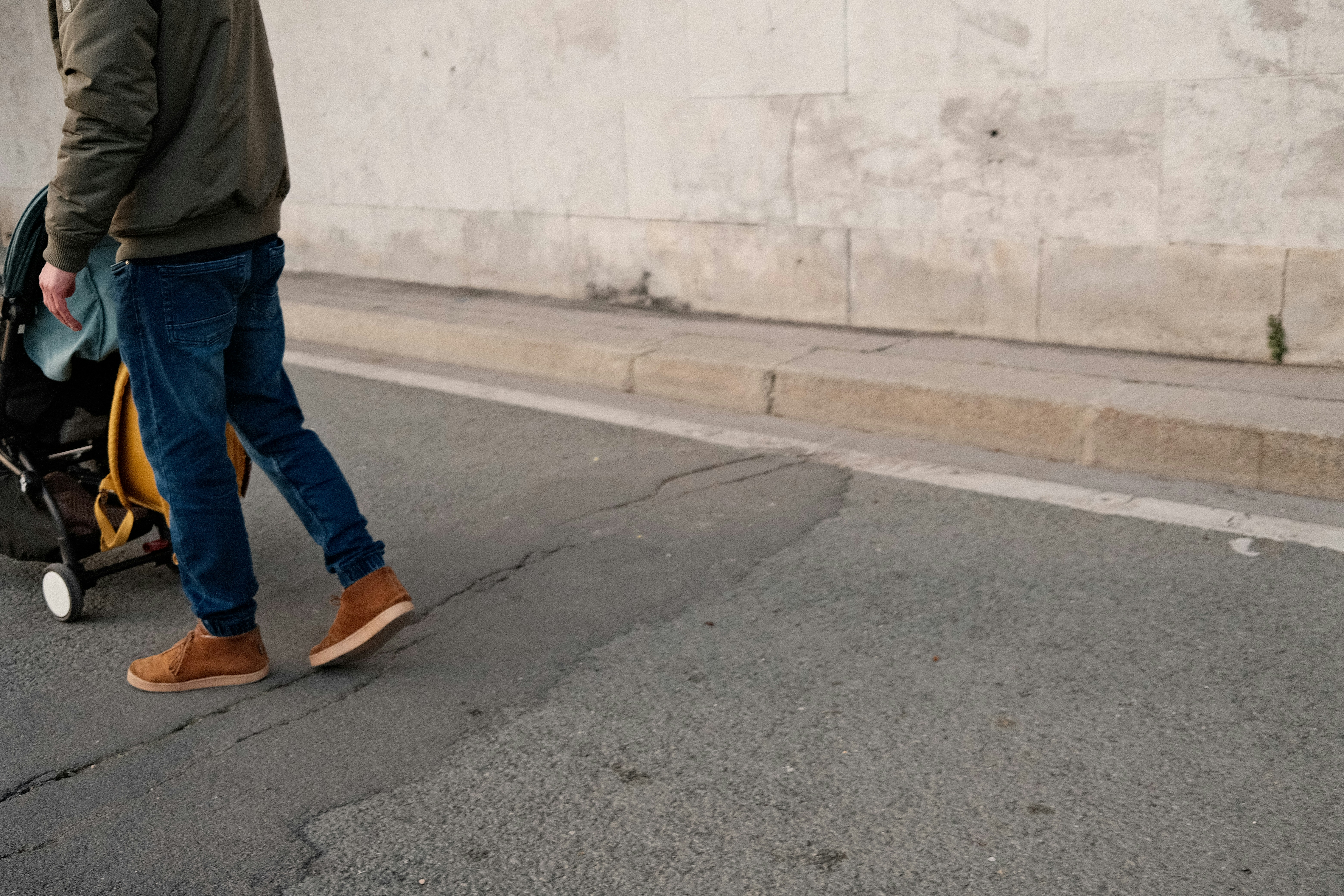 a man is walking down the street with his luggage