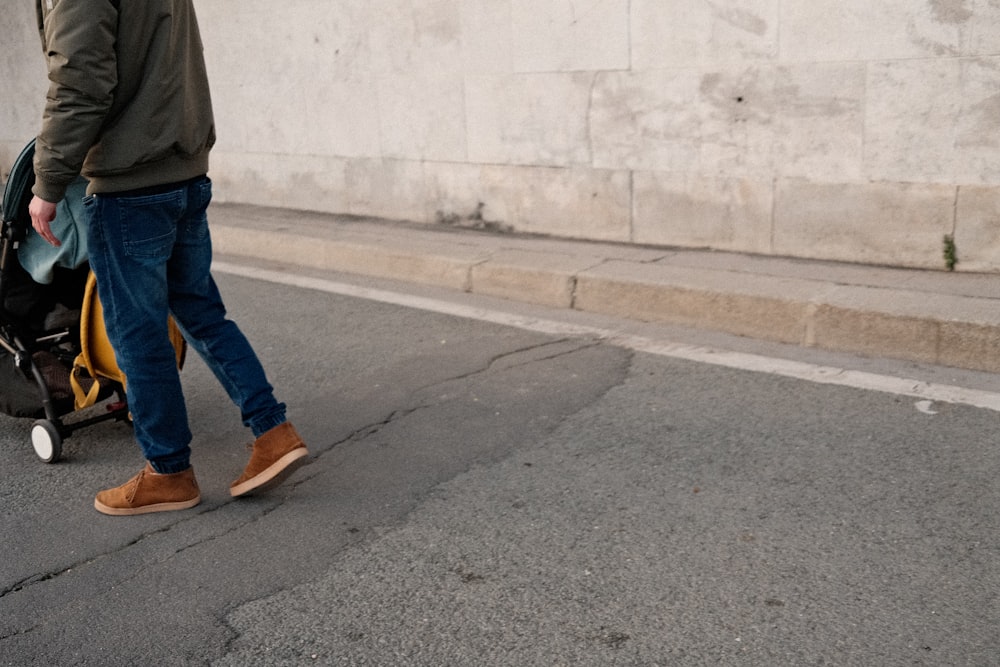 a man is walking down the street with his luggage