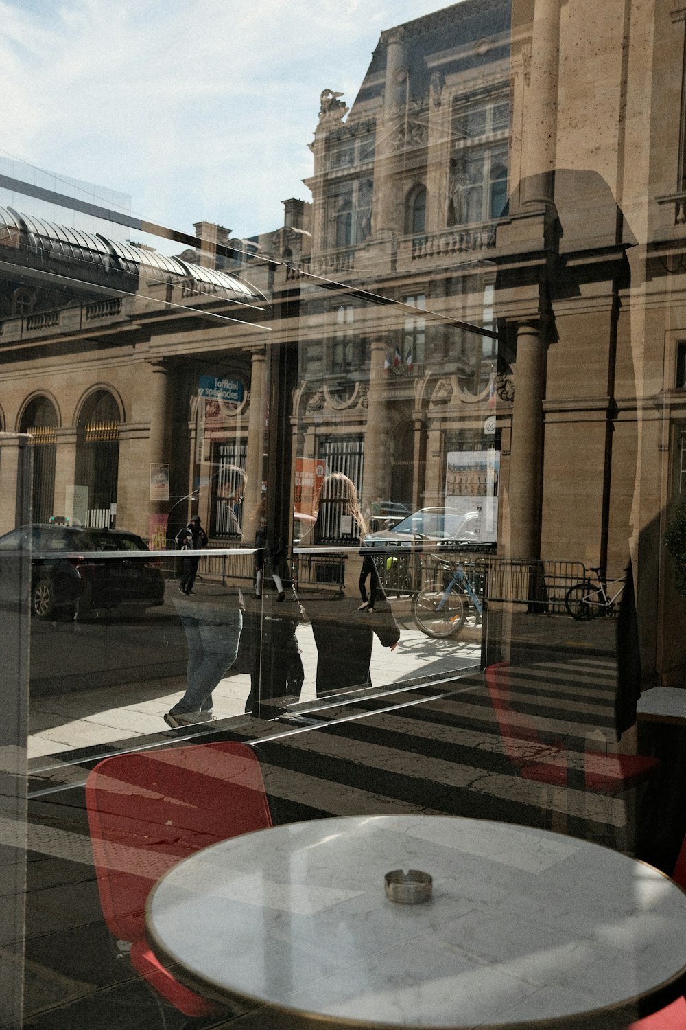 a reflection of a man walking down a street