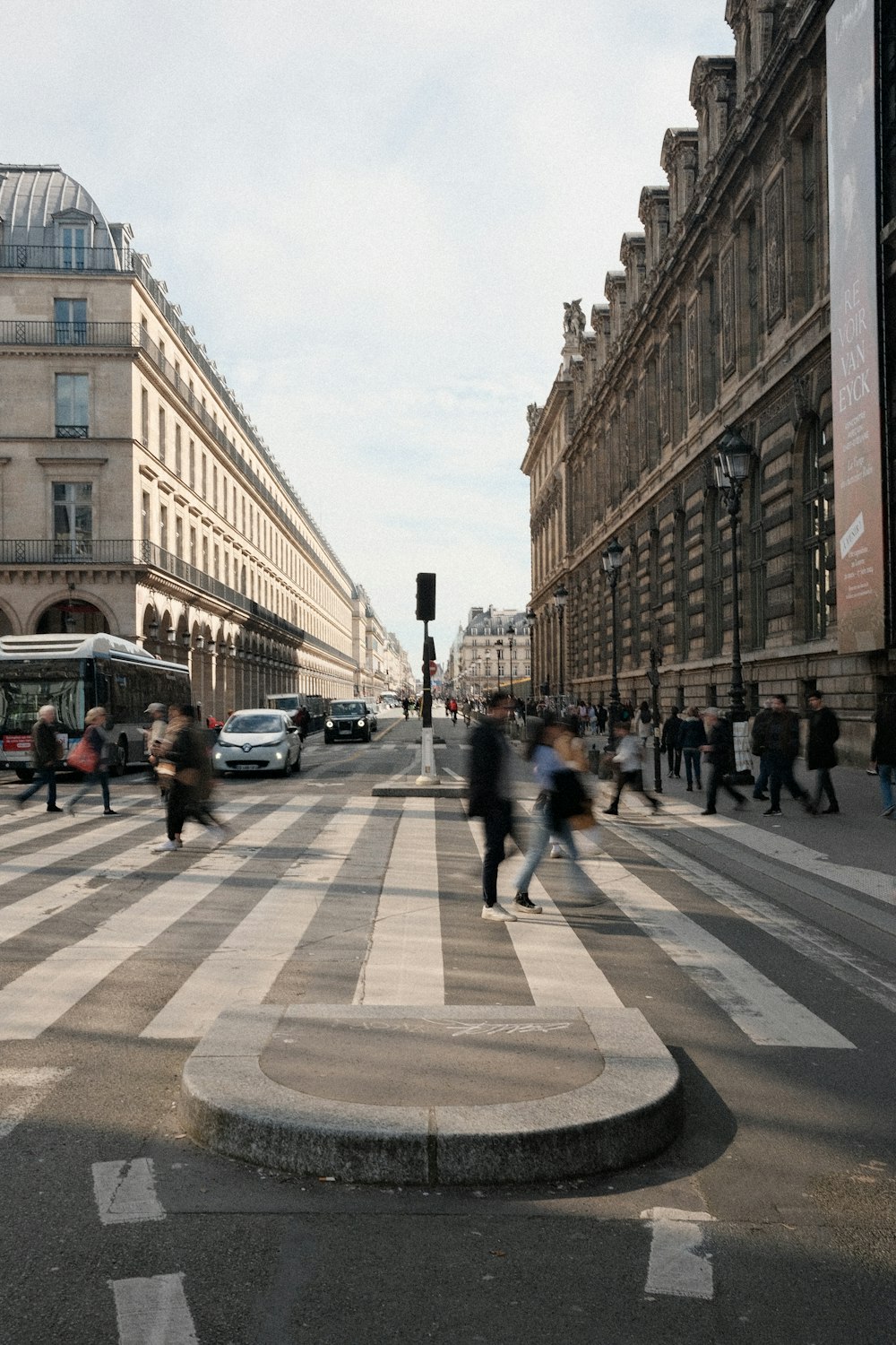 a group of people walking across a cross walk