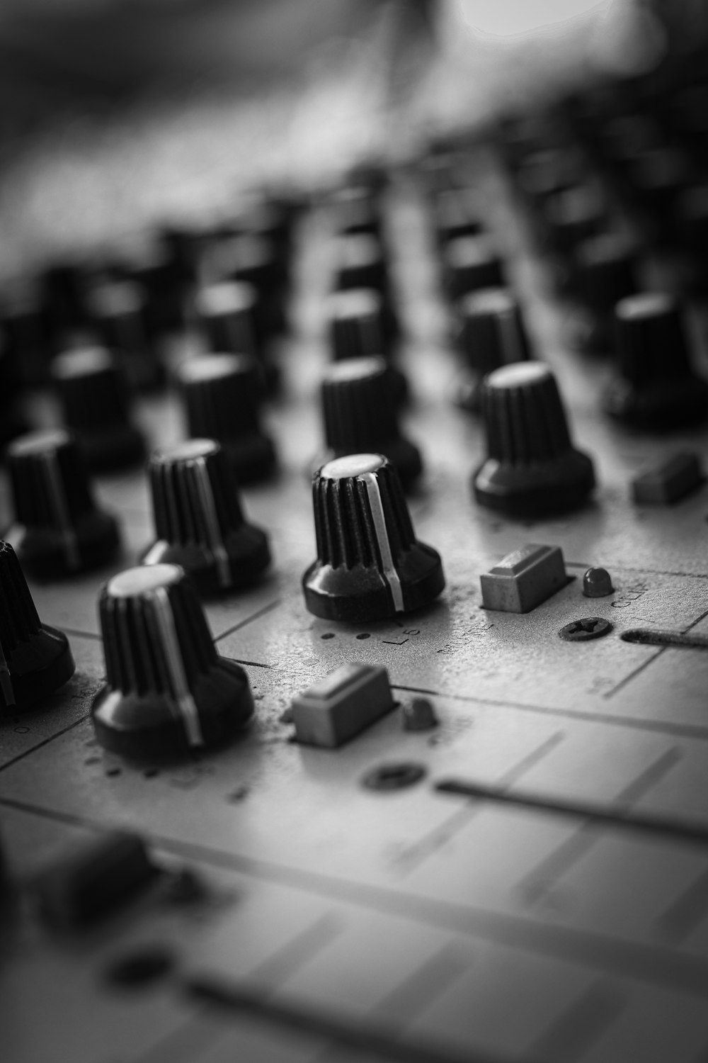 a close up of a mixing board with knobs