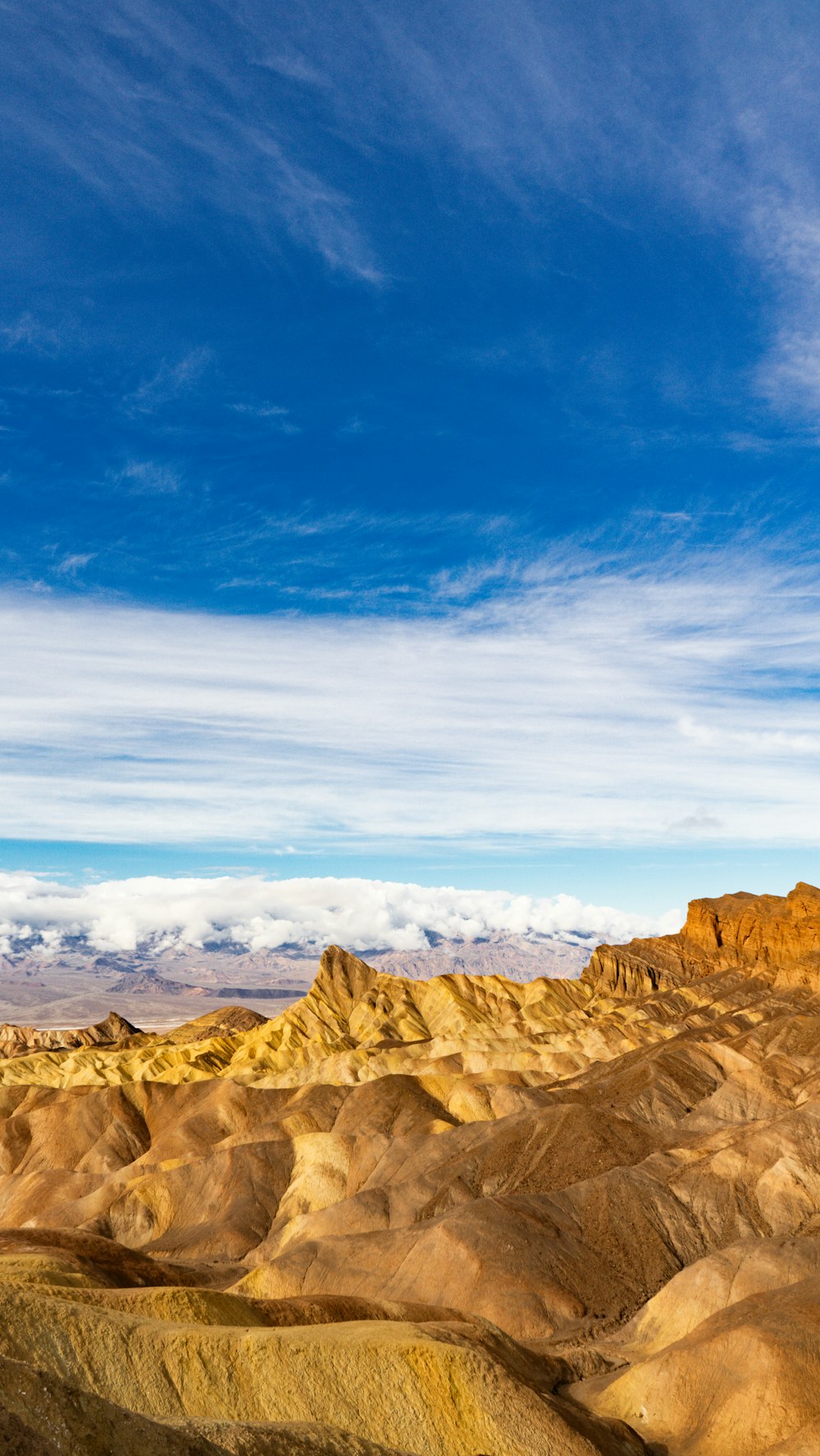 a view of a mountain range from the top of a hill