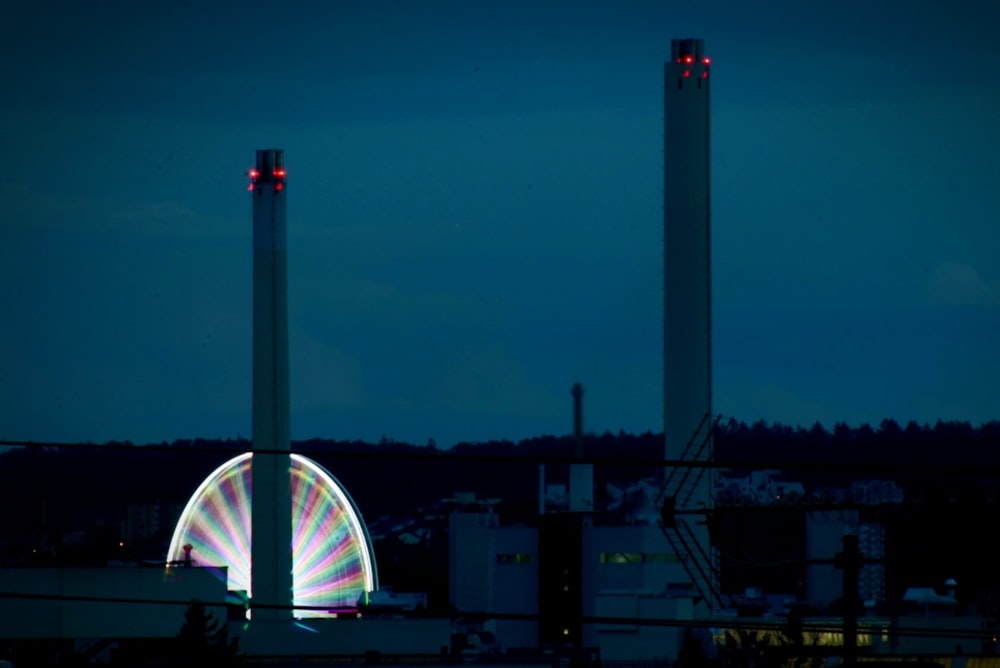 a ferris wheel lit up in the night sky