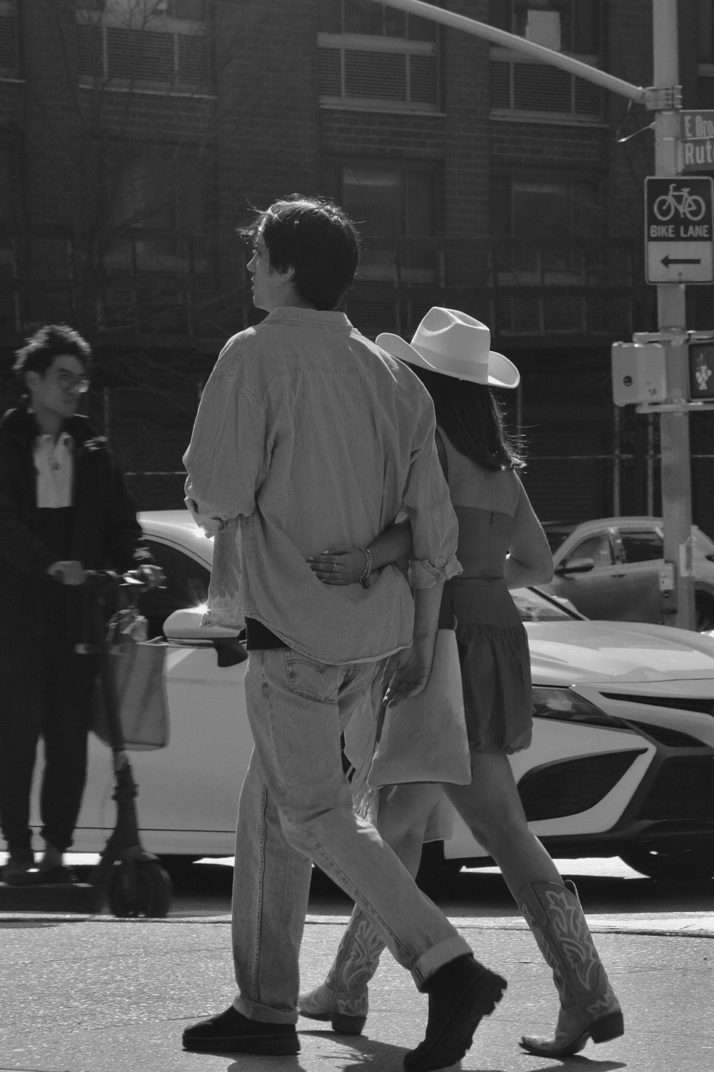 a man and a woman crossing the street