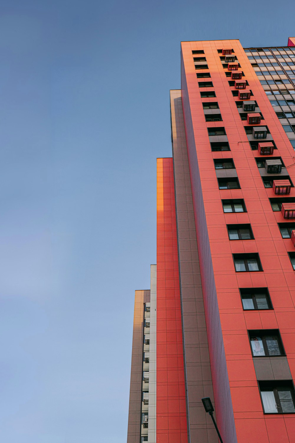 a tall red building with a clock on it's side