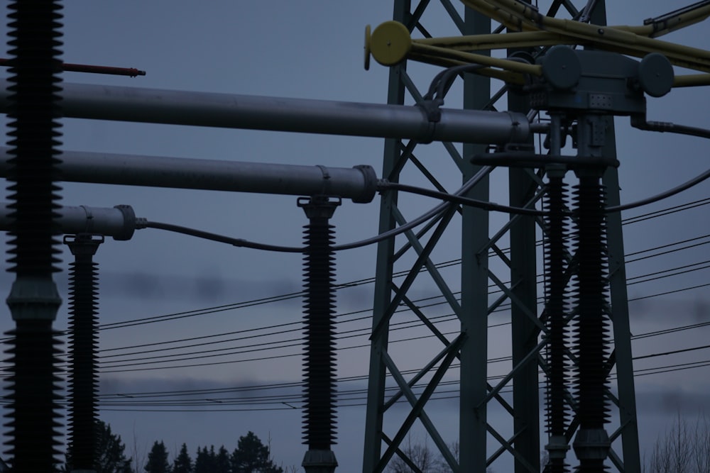 a power pole with wires and wires in the foreground