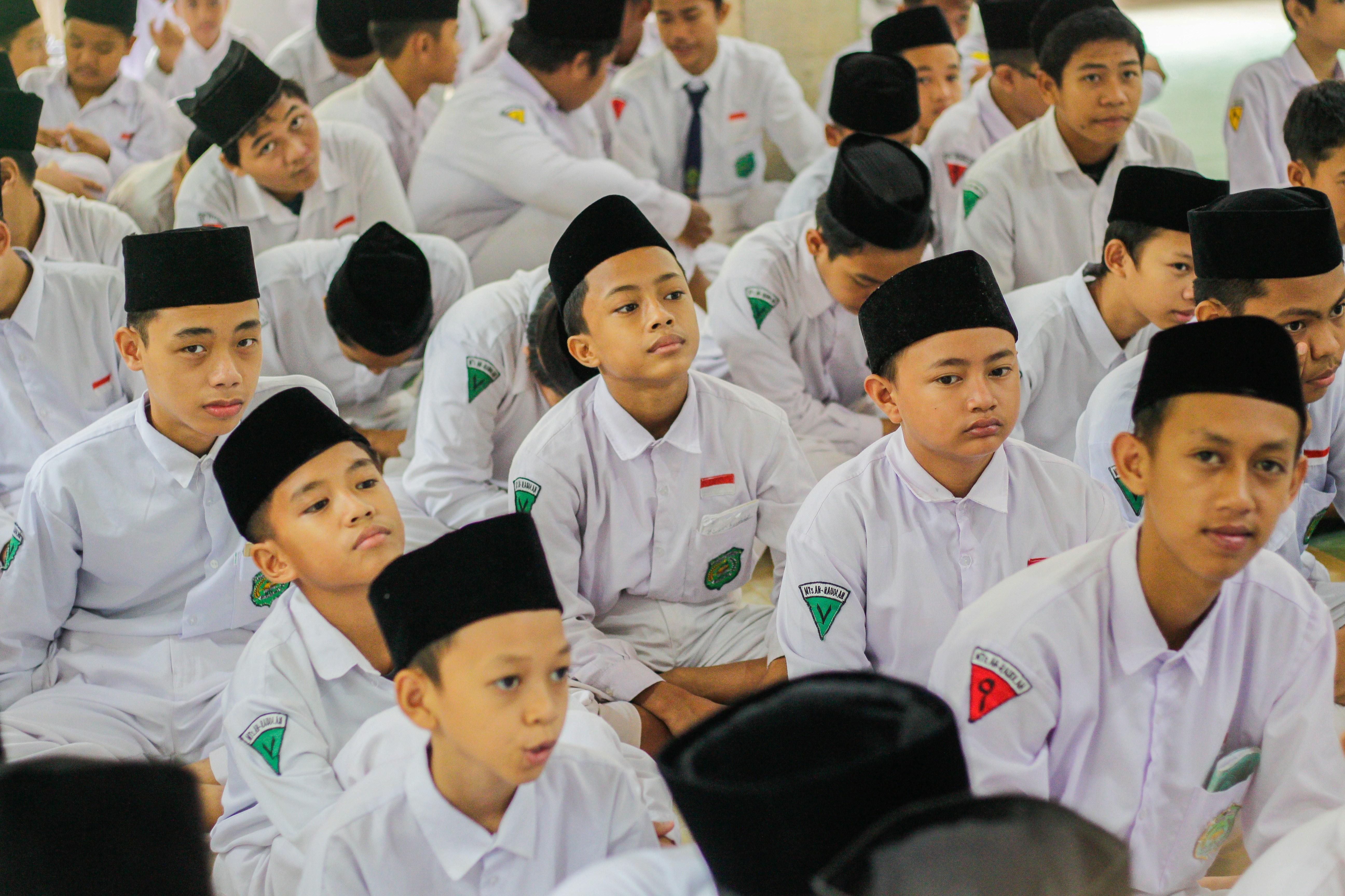 a group of young men sitting next to each other