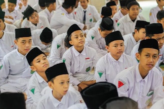 a group of young men sitting next to each other