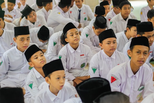 a group of young men sitting next to each other