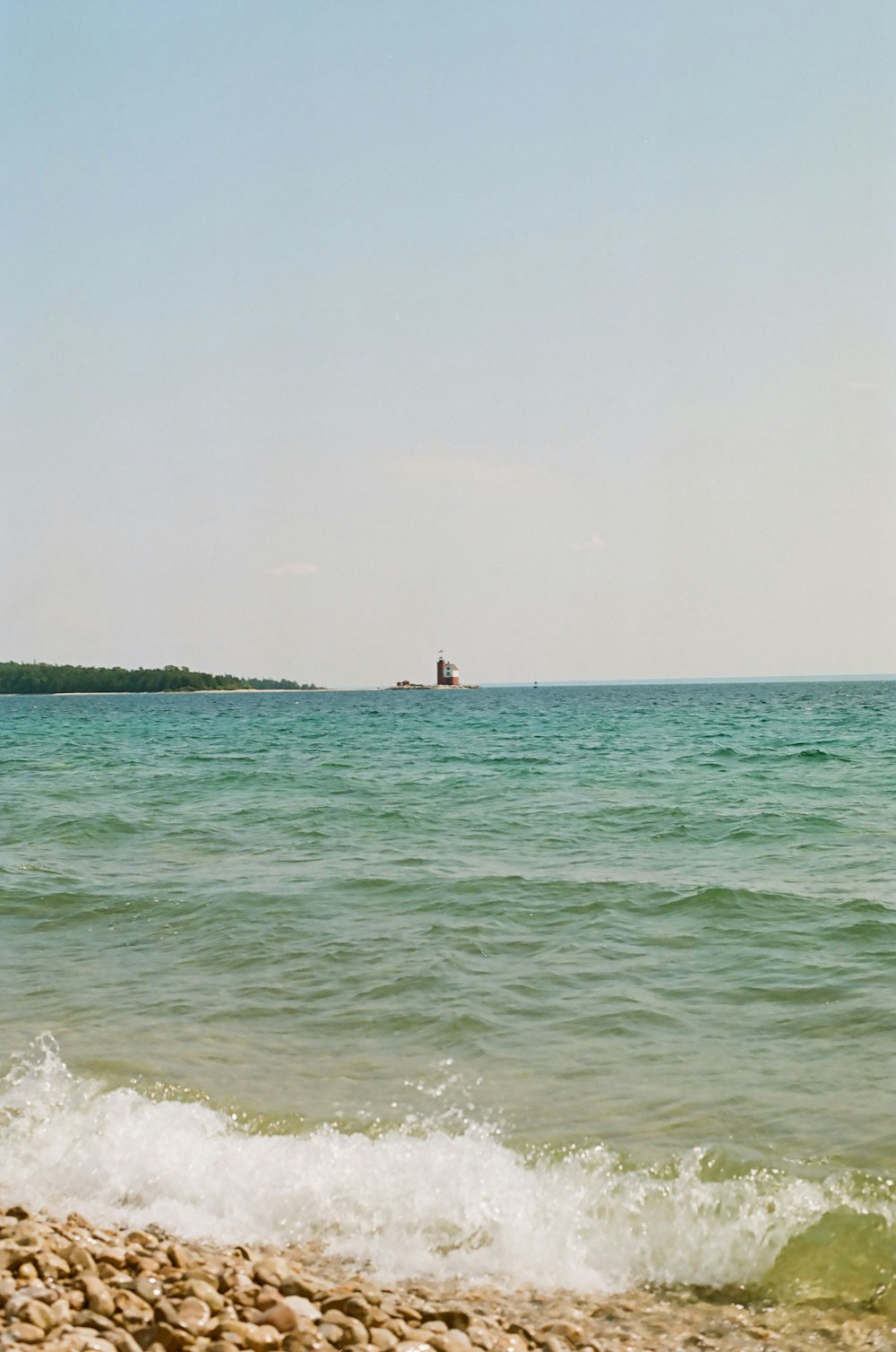 a man riding a surfboard on top of a wave in the ocean