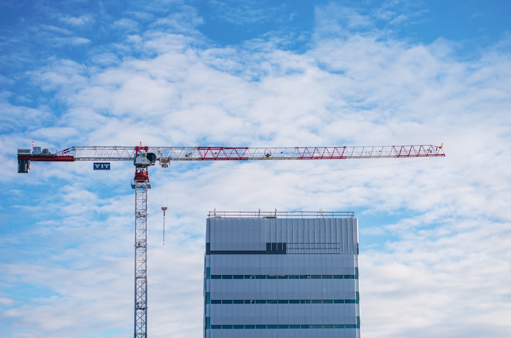 a large crane standing next to a tall building