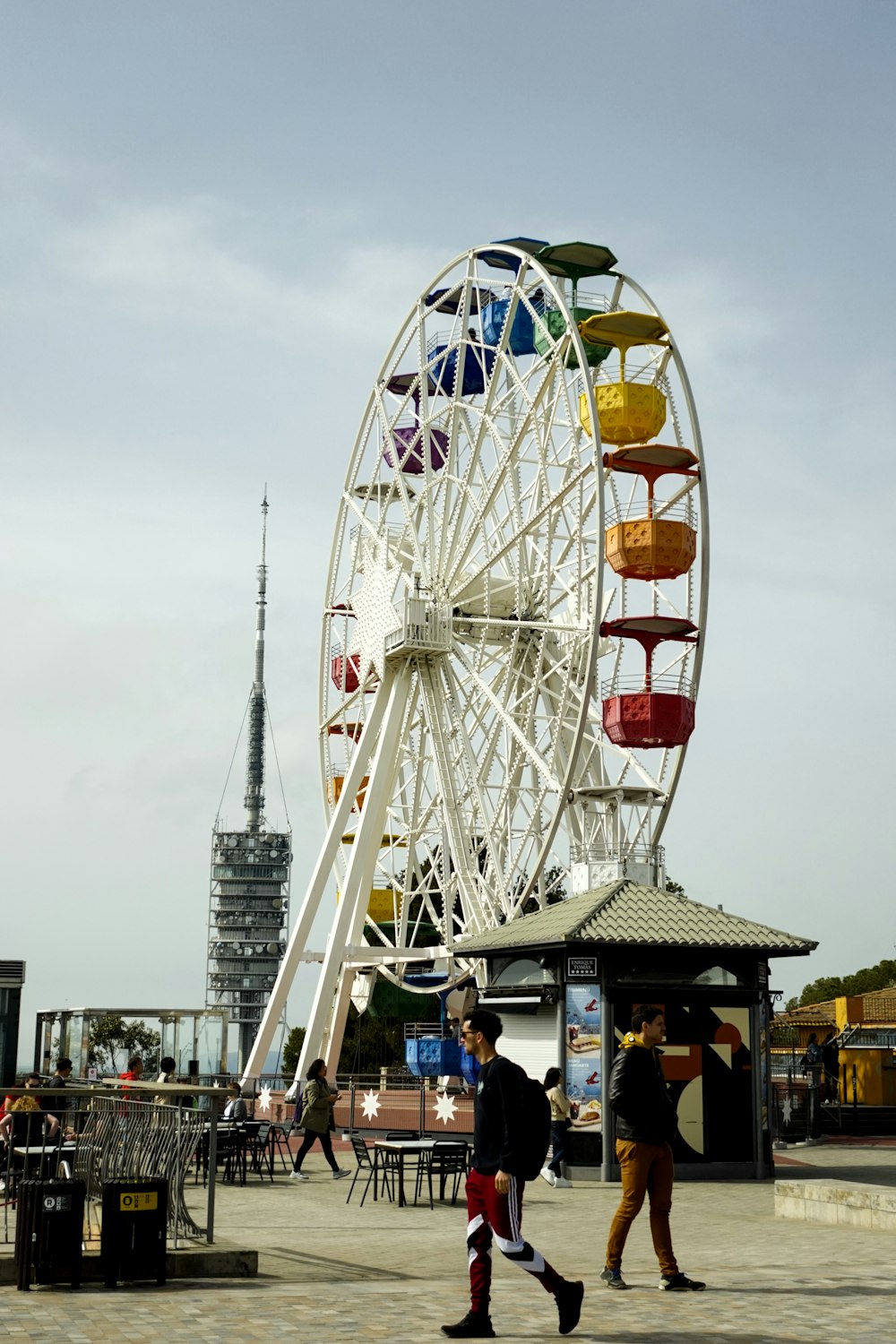 a ferris wheel with people walking around it