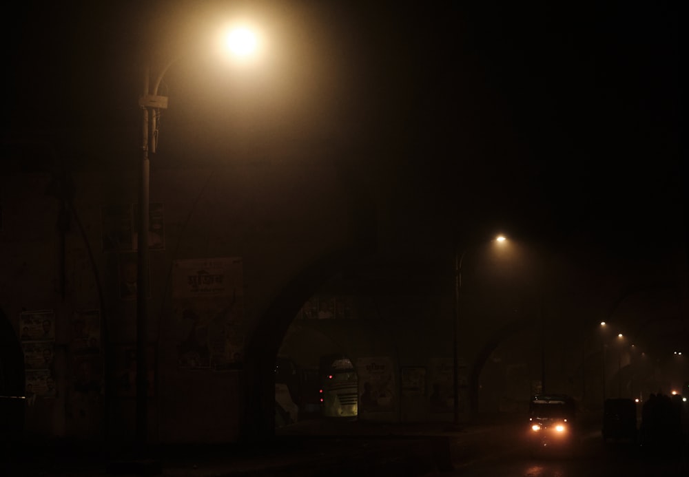 a car driving down a street at night