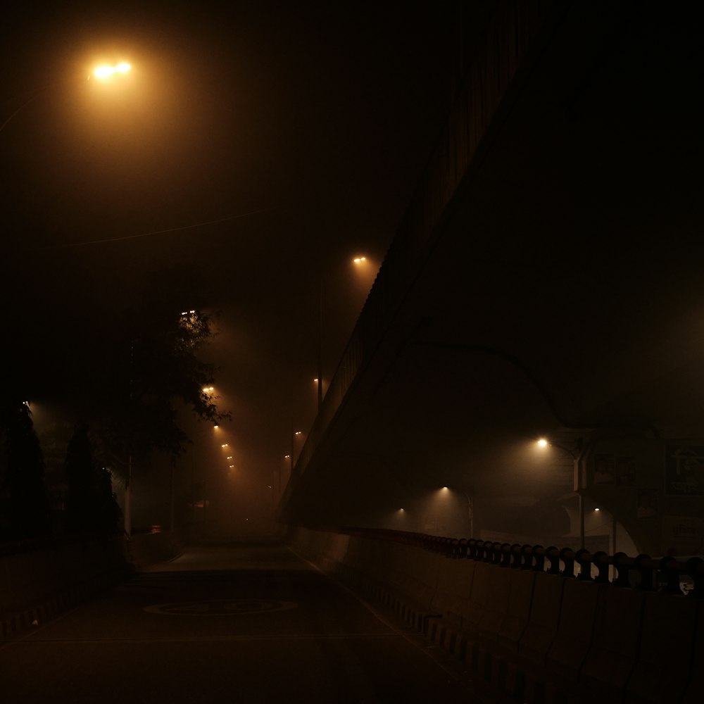 a foggy street at night with street lights